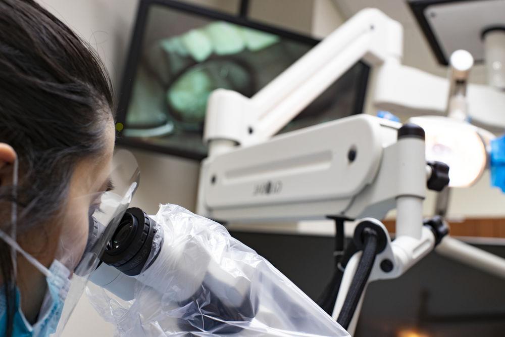 An Endodontics graduate certificate student working in a clinic. 